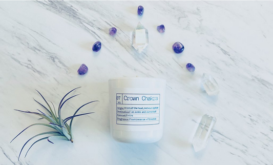 The Crown Chakra candle is a warm, rich blend of frankincense and smokey fireside.